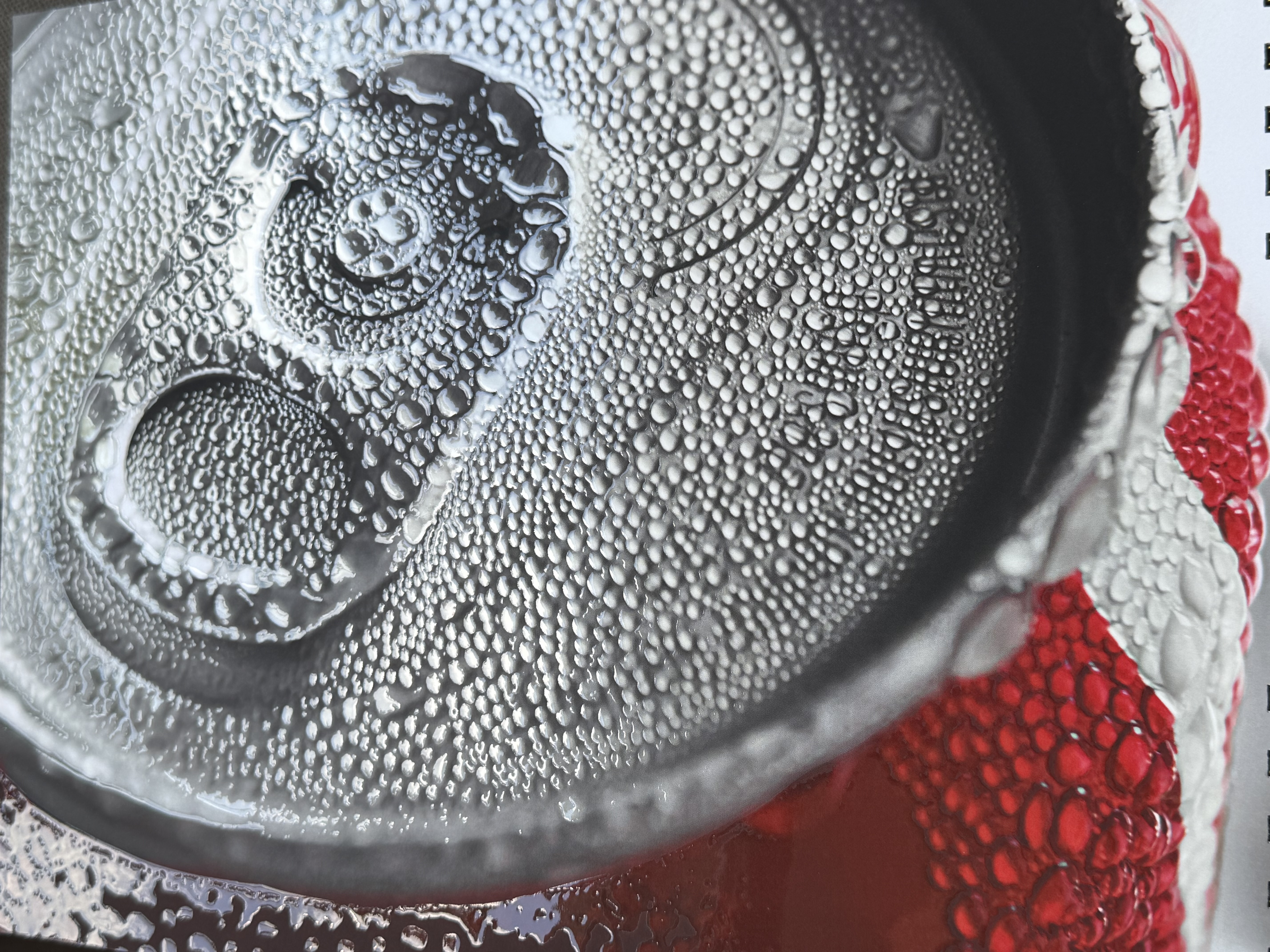 Close-up of an embellished beverage can with tactile condensation detail